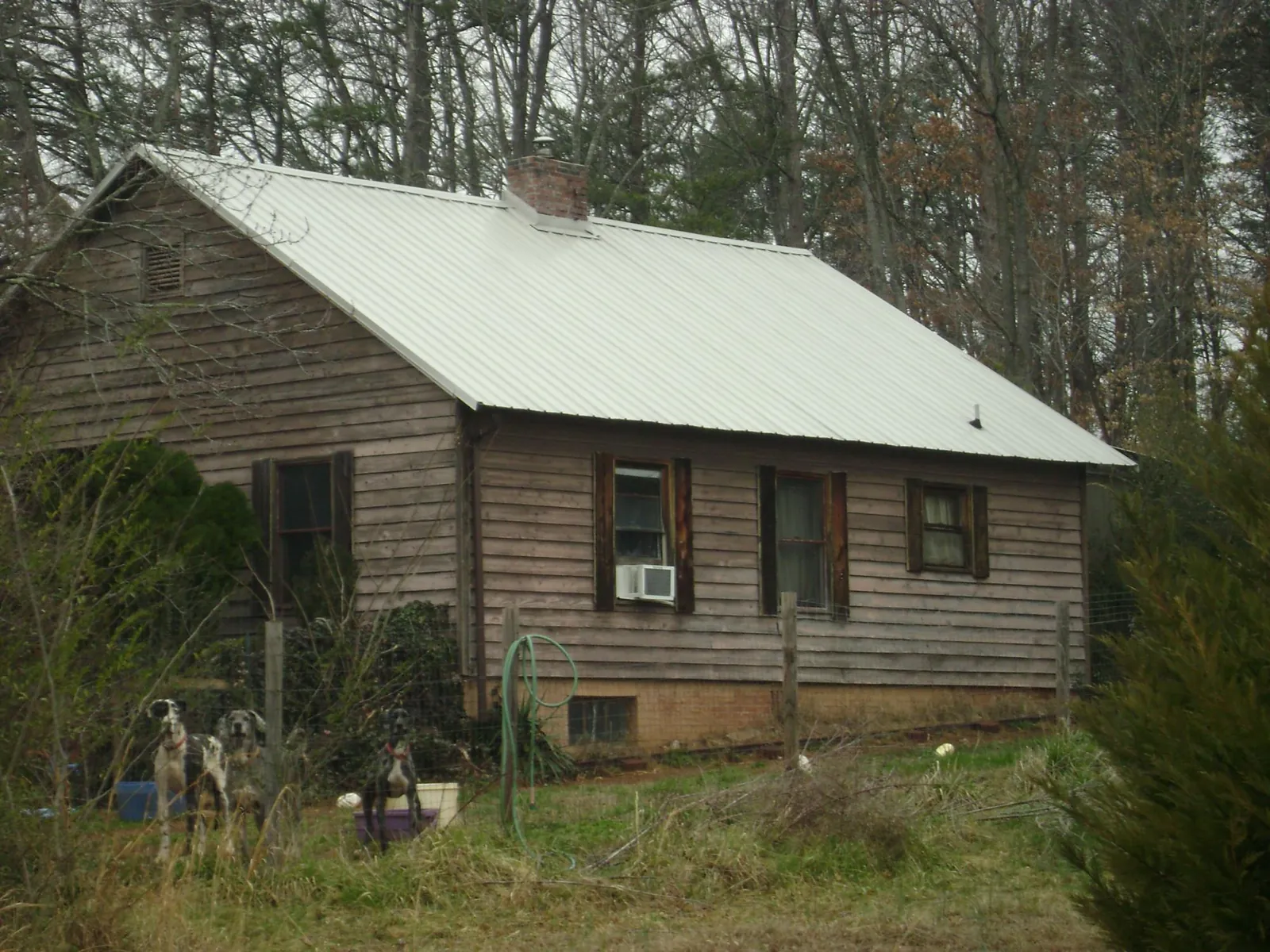 White metal roof on an old wood sided farmhouse, from a Metal Roof Installation job in Bradley